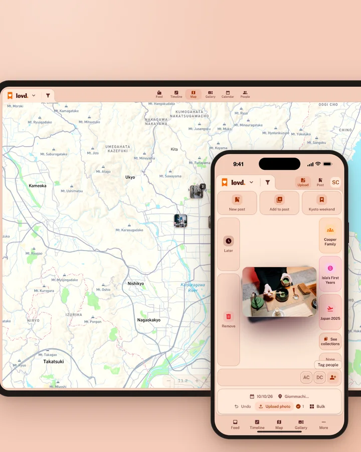 Lovd on a laptop and a phone: the map of Kyoto dotted with family photos, one just landing, while the phone sorts the next new photo.